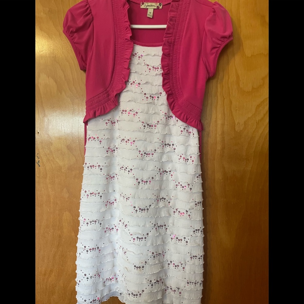 Super cute and girly white ruffle dress with pink circle sequins. Size 14.
